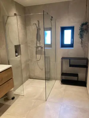 a bathroom with a shower with a glass door at The Oyster House With Private Parking in Zandvoort