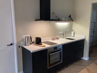a kitchen with a sink and a counter top at The Oyster House With Private Parking in Zandvoort