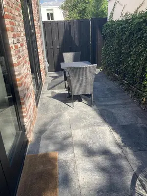 a patio with two chairs and a table on a sidewalk at The Oyster House With Private Parking in Zandvoort