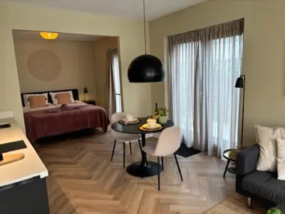 a room with a bed and a table and a couch at The Oyster House With Private Parking in Zandvoort