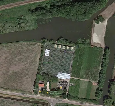 an aerial view of a farm in a river at De Groote Wijzend in Lutjebroek