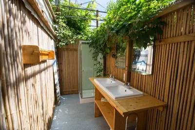 an outdoor bathroom with a sink and a mirror at De Groote Wijzend in Lutjebroek