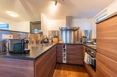 a kitchen with a sink and a counter at Watervillashiraz in Aalsmeer