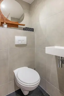 a bathroom with a white toilet and a sink at Watervillashiraz in Aalsmeer