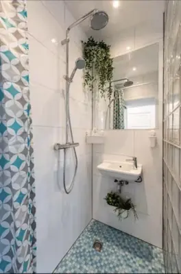 a bathroom with a sink and a shower at Cozy 2-bedroom apartment in Amsterdam