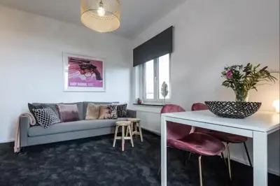 a living room with a couch and a table at Cozy 2-bedroom apartment in Amsterdam