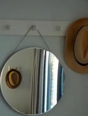 a mirror in a room with a hat and a window at White Sand Beach in Bergen aan Zee
