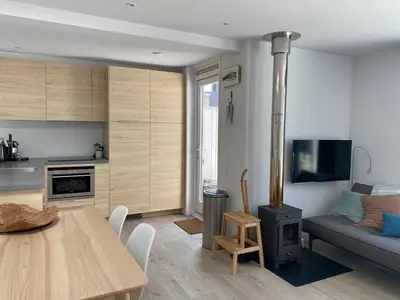 a kitchen and living room with a table and a couch at White Sand Beach in Bergen aan Zee