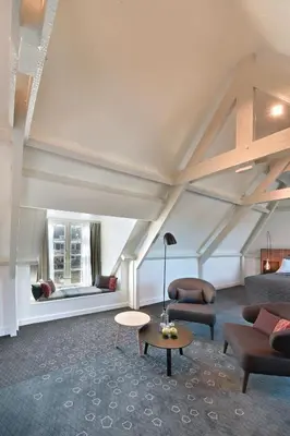 a living room with a couch and a table at De Nederlanden, Restaurant & Boutique Hotel in Vreeland