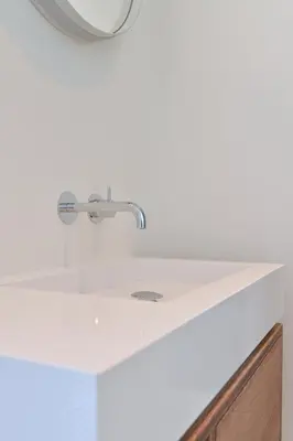 a white sink in a bathroom with a mirror at De Nederlanden, Restaurant & Boutique Hotel in Vreeland