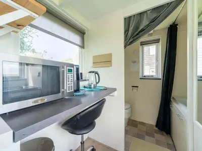 a kitchen with a counter with a microwave on it at Holiday home in Burgerbrug near the beach in Burgerbrug