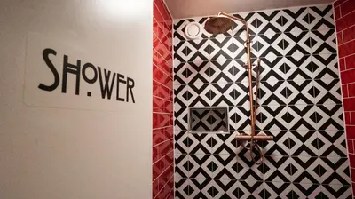 a shower in a bathroom with a wall at Hotel Internationaal in Amsterdam