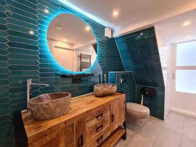 a bathroom with a sink and a mirror and a toilet at Hotel Internationaal in Amsterdam