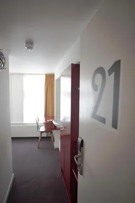 a room with a door with the number on the wall at Hotel Internationaal in Amsterdam