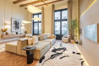 a living room with a couch and a table at Newly renovated luxurious 200 SQM loft in city centre in Amsterdam