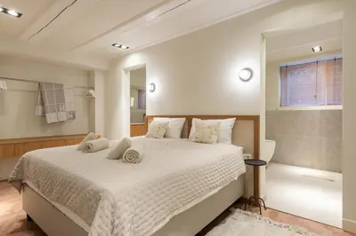 a bedroom with a large white bed and a window at Newly renovated luxurious 200 SQM loft in city centre in Amsterdam