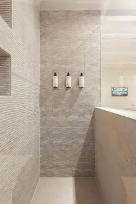 a bathroom with three soap dispensers on the wall at Newly renovated luxurious 200 SQM loft in city centre in Amsterdam