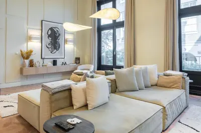 a living room with a couch and a table at Newly renovated luxurious 200 SQM loft in city centre in Amsterdam