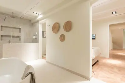 a white room with two plates on the wall at Newly renovated luxurious 200 SQM loft in city centre in Amsterdam