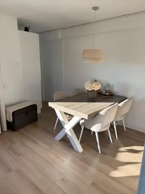 a dining room table and chairs in a room at Sea La Vie- Appartement aan het strand in Zandvoort aan Zee! in Zandvoort