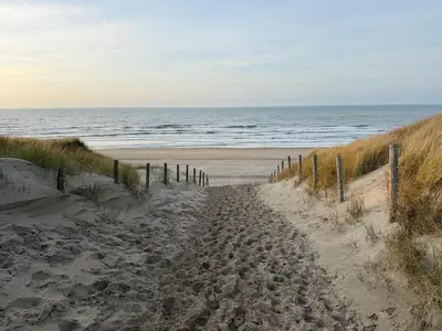 a sandy path leading to the ocean on a beach at Sea La Vie- Appartement aan het strand in Zandvoort aan Zee! in Zandvoort