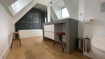a bathroom with a sink and a toilet at Villa M in Schoorl