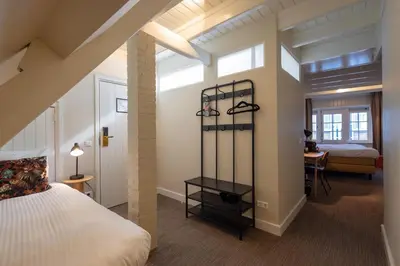 a bedroom with a bed and a desk in a room at Hotel Spaander BW Signature Collection in Volendam
