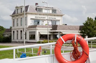 a boat with a life preserver on the front of a building at Van der Valk Hotel Avifauna in Alphen aan den Rijn