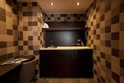 a small kitchen with a sink and a counter at Van der Valk Hotel Avifauna in Alphen aan den Rijn