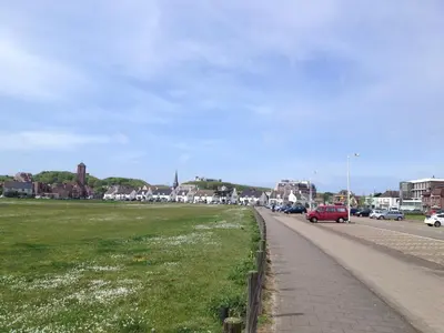 a street with cars parked on the side of a road at Badhotel Zeecroft in Wijk aan Zee