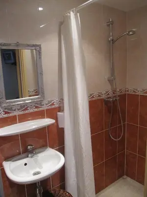 a bathroom with a sink and a shower at Badhotel Zeecroft in Wijk aan Zee