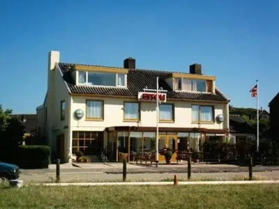 a building with a basketball hoop in front of it at Badhotel Zeecroft in Wijk aan Zee