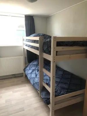 two bunk beds in a room with a window at gouwzicht in Amsterdam