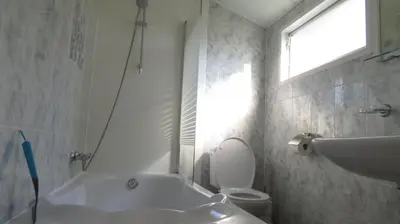 a bathroom with a tub and a toilet and a sink at gouwzicht in Amsterdam