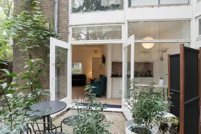 a glass extension to a house with plants at B&B Amsterdam West in Amsterdam