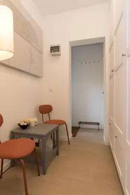 a dining room with a table and chairs and a door at B&B Amsterdam West in Amsterdam