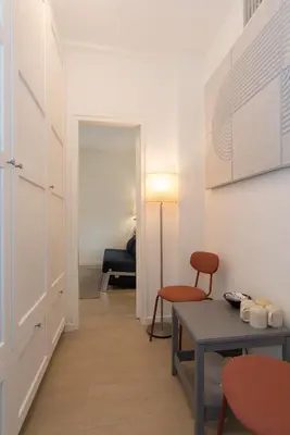 a living room with a table and a chair at B&B Amsterdam West in Amsterdam