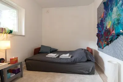a bedroom with a bed and a painting on the wall at B&B Amsterdam West in Amsterdam