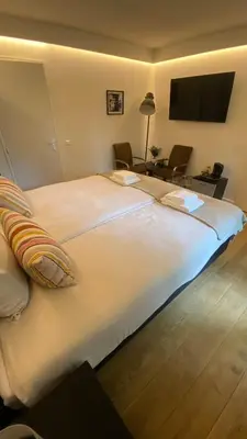 a large white bed in a hotel room at Hotel 1900 in Bergen