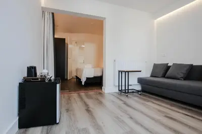 a living room with a couch and a table at Hotel 1900 in Bergen