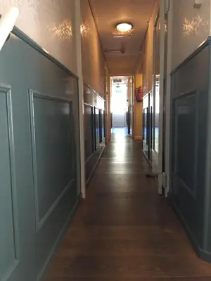 a corridor of an office building with doors and a hallway at Hotel 1900 in Bergen