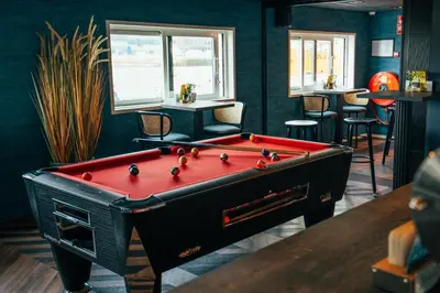 a ping pong table in a room with a pool table at Botel in Amsterdam
