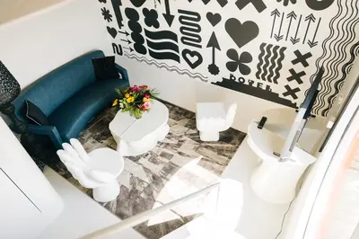 a living room with a blue couch and white furniture at Botel in Amsterdam