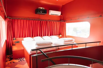 a red room with a bed and a window at Botel in Amsterdam