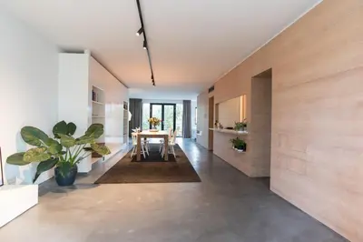 a living room with a table and a dining room at City centre Loft on the historic Canal in Utrecht