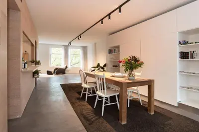 a kitchen and dining room with a wooden table and chairs at City centre Loft on the historic Canal in Utrecht