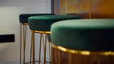 a row of green bar stools in a room at Unieke beleving op het water, de Prinsenboot. in Spaarndam
