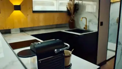 a kitchen with a sink and a counter with a pot at Unieke beleving op het water, de Prinsenboot. in Spaarndam