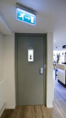 a door in an office with a sign above it at City Hotel Amsterdam in Amsterdam