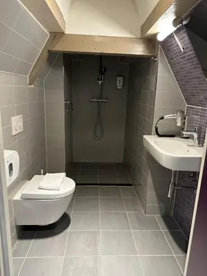 a bathroom with a toilet and a sink at City Hotel Amsterdam in Amsterdam